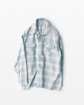 Light blue plaid shirt on a white background
